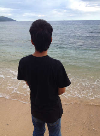 man back view against the background of the beachの写真素材