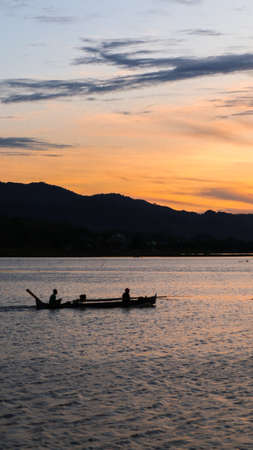 Fisherman on His Boat at Sunset. Fishermen Boat at Sunsetの写真素材