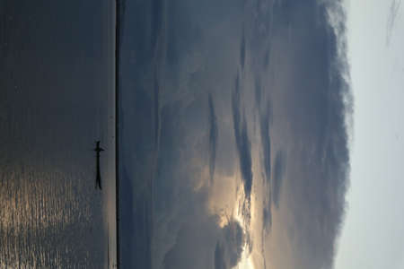 Fisherman on His Boat at Sunset.の写真素材