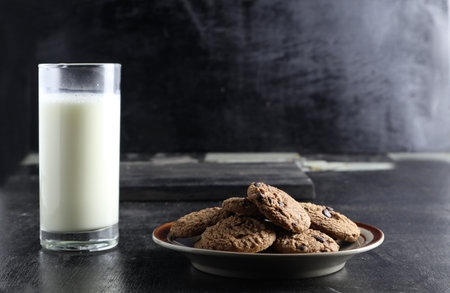 cookies and milk on black background. Space for textの写真素材