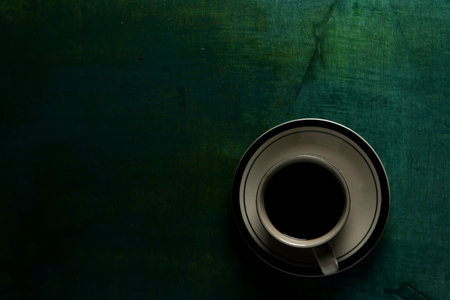 Cup of coffee on green background