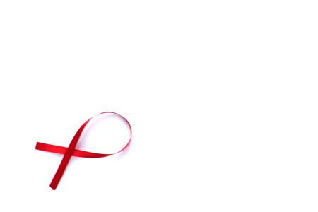 Red Support Ribbon isolated on white background. World aids day and national HIV/AIDS and aging awareness month with red ribbon. copyspace areaの写真素材