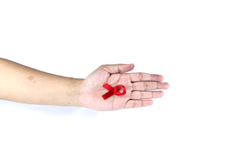 hand symbol with red ribbonの写真素材