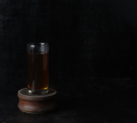 glass of tea on a black backgroundの写真素材
