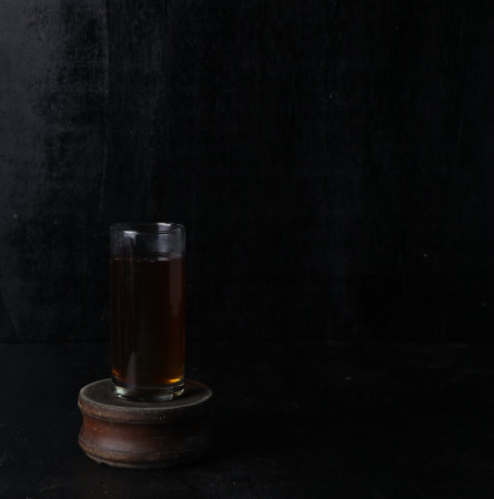 glass of tea on a black backgroundの写真素材