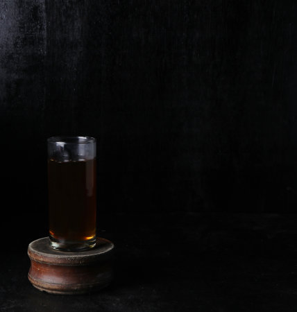 glass of tea on a black backgroundの写真素材