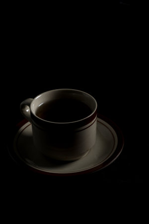 Cup tea isolated on a black backgroundの写真素材