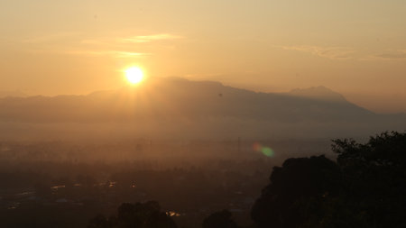 The sun rises over the mountainsの写真素材