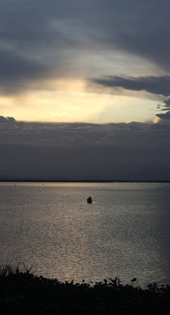 Fisherman Silhouette on His Boatの写真素材