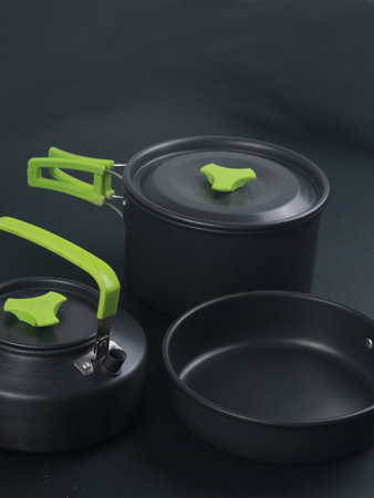 cookware set, antique dinner set isolated on black background, black metal cookware setの写真素材