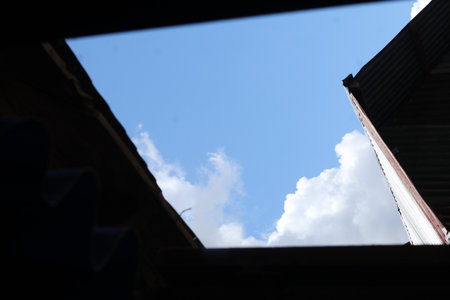Blue sky and cloud in the roof of a house, Thailand.