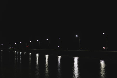 Reflection in the water of a river at night with street lightsの写真素材