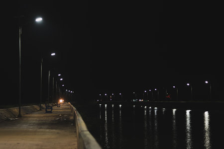 Night view of a pier in the middle of a lake with lightsの写真素材
