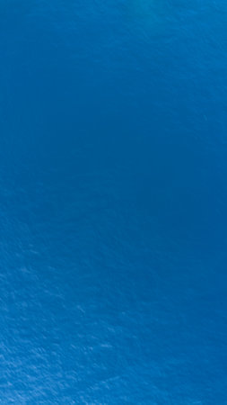 blue water background texture with some smooth lines in it and some spotsの写真素材