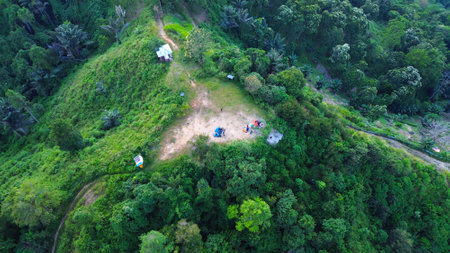 Aerial view of people camping on top of mountain in the jungleの写真素材