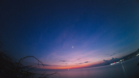 Night sky with stars and milky way over the sea. Beautiful natural backgroundの写真素材
