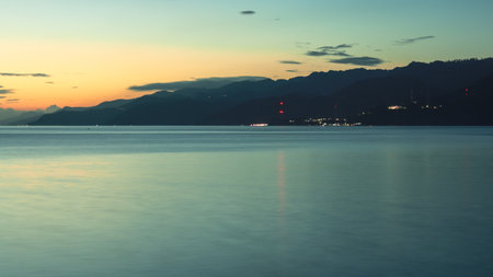Night view of the sea and mountains in Gorontalo, Indonesiaの写真素材