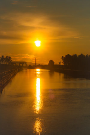 Golden Sunset Over River Landscapeの写真素材