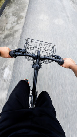 First-Person View of Cyclist Riding Bike on Roadの写真素材
