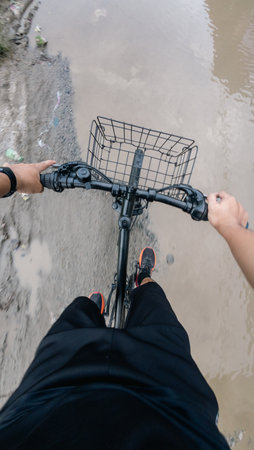 POV Shot of Person Riding Bike Through Puddle