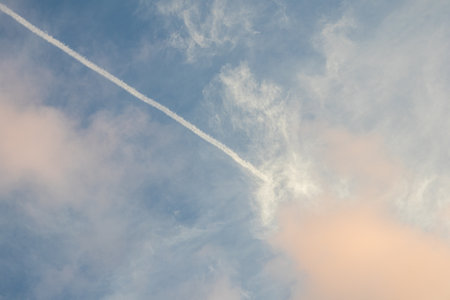 Airplane Contrail in Blue Cloudy Sky