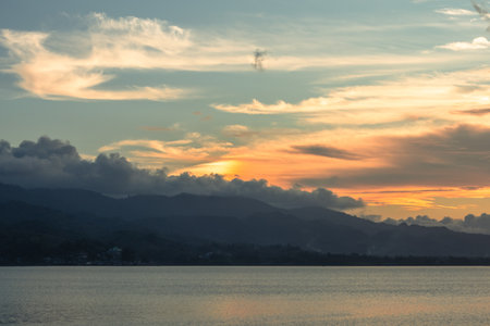 Scenic View of Mountains and Lake at Sunsetの写真素材