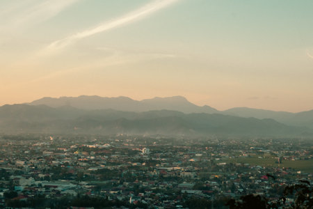 Scenic View of Cityscape and Mountains at Dusk