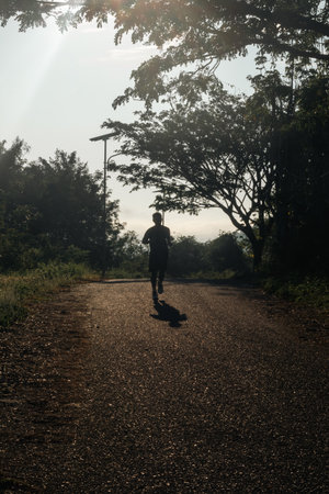 Silhouette of Person Running on Path Outdoors