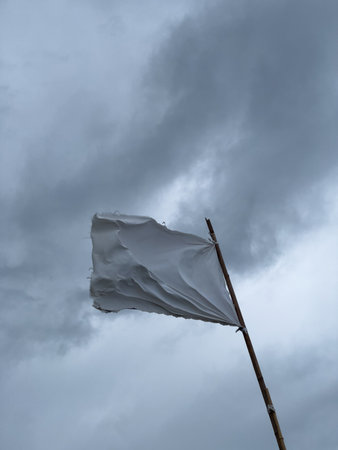 White Flag Against Cloudy Skyの写真素材