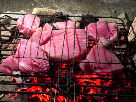 Fresh Tuna Steaks Grilling Over Glowing Coalsの写真素材