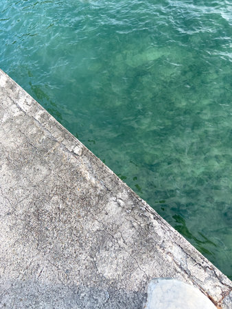 Clear Ocean Water and Concrete Pierの写真素材