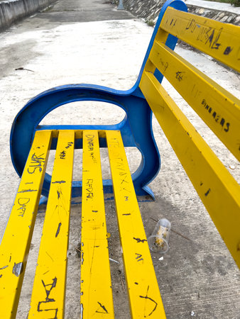 Yellow and Blue Bench with Graffitiの写真素材