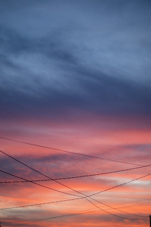 Scenic Sunset Sky with Clouds and Wiresの写真素材