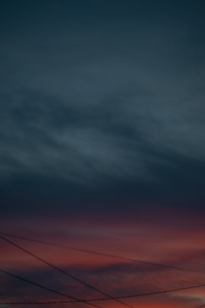 Sunset and stormy sky with electric wire in the foreground.の写真素材