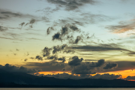Scenic Sunset Sky Over Silhouette of Mountainの写真素材