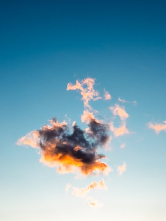 Single Cloud Lit by Golden Hour Lightの写真素材