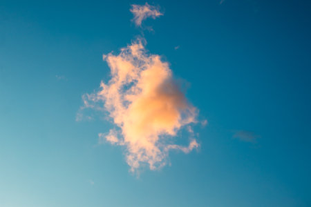 Orange Cloud Against Blue Skyの写真素材