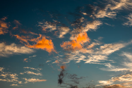 Cloudscape, Colored Clouds at Sunset near the Ocean on a Blue Sky