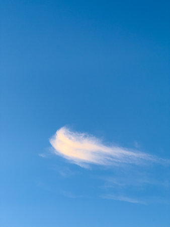 Single Cloud Against Blue Skyの写真素材