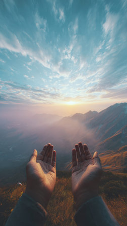 Hands Reaching Towards a Majestic Mountain Sunsetの素材