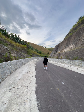 Man Walking on a Winding Road