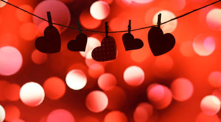 Hearts hanging in the shadows. On a yellow and orange background