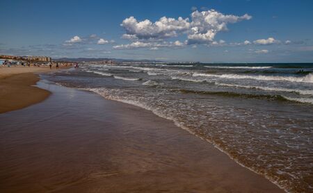 coastline with clouds, sandy shore, blue sky, white cloudsの写真素材