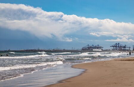 coastline with clouds, sandy shore, blue sky, white cloudsの写真素材
