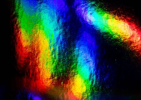 multicolored rainbow highlights on a black backgroundの写真素材