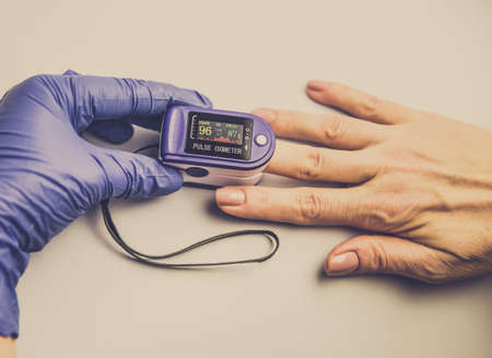 Measurement of the patients blood oxygenation level. Using a pulse oximeter.の写真素材
