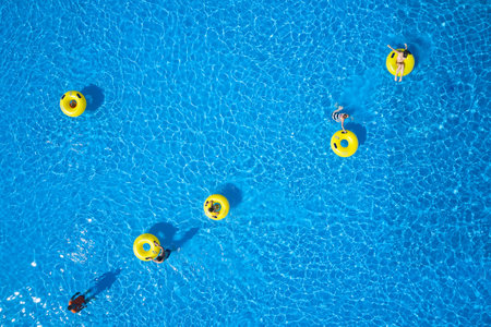 Top view - young people relax in swimming pool at bubble bath.のeditorial素材