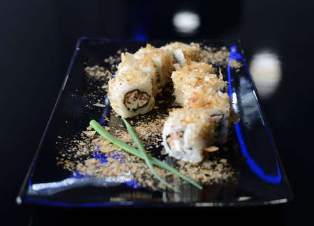 Sushi rolls on black dish.の写真素材