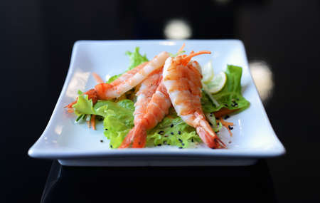 Fresh summer salad with shrimp on white dish. Concept of healthy eating.の写真素材