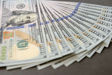 Pile of one hundred dollar banknotes as money background. New dollar bills spread in financial...